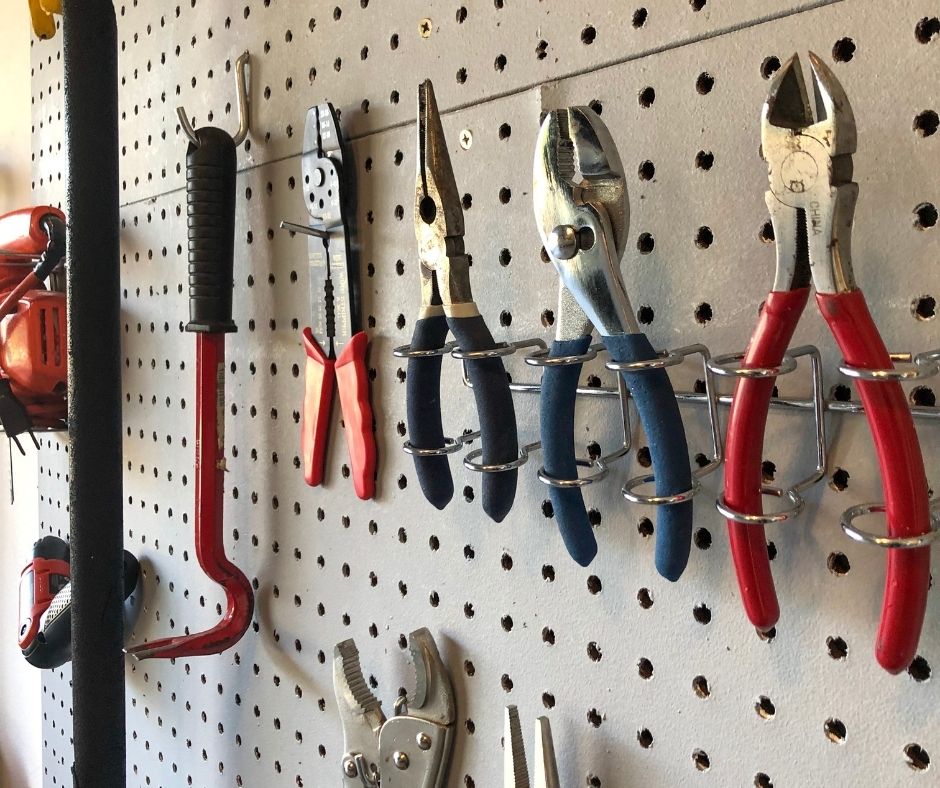 Garage hooks, racks, and pegboards used for vertical storage